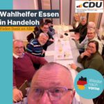 Gruppe von Personen an einem langen Tisch